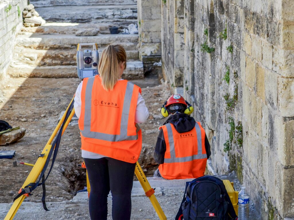 Professionals conducting an archaeological survey at historic ruins in Périgueux, France.
